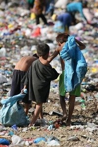 children scavenge on rubbish tip
